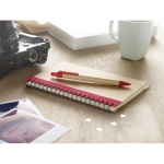 Recycled paper notepad with colour detail and pen, B6 red colour ambient view