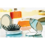 Small round mirror with hairbrush as a practical beauty gift silver colour ambient view