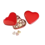 Small heart-shaped metal tin with heart-shaped sweets red colour