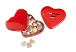 Small heart-shaped metal tin with heart-shaped sweets red colour