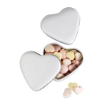 Small heart-shaped metal tin with heart-shaped sweets white colour