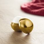 Ball-shaped lip balm in box, SPF 15 UV gold colour ambient view