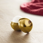 Ball-shaped lip balm in box, SPF 15 UV gold colour main ambient view