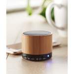 Round wooden Bluetooth speaker black colour ambient view