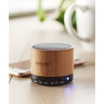 Round wooden Bluetooth speaker black colour main ambient view