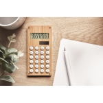 8-digit dual calculator in a sustainable bamboo design wood colour ambient view