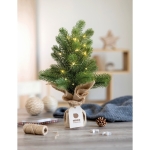 Small plastic Christmas tree as a decoration for the office green colour main ambient view