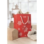 Medium red gift bag with a white snowflake motif red colour second main view