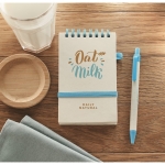 Notepad & matching pen made from recycled milk cartons, A6 turquoise colour main ambient view