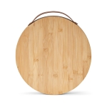 Bamboo chopping board with handle and three utensils natural colour front view